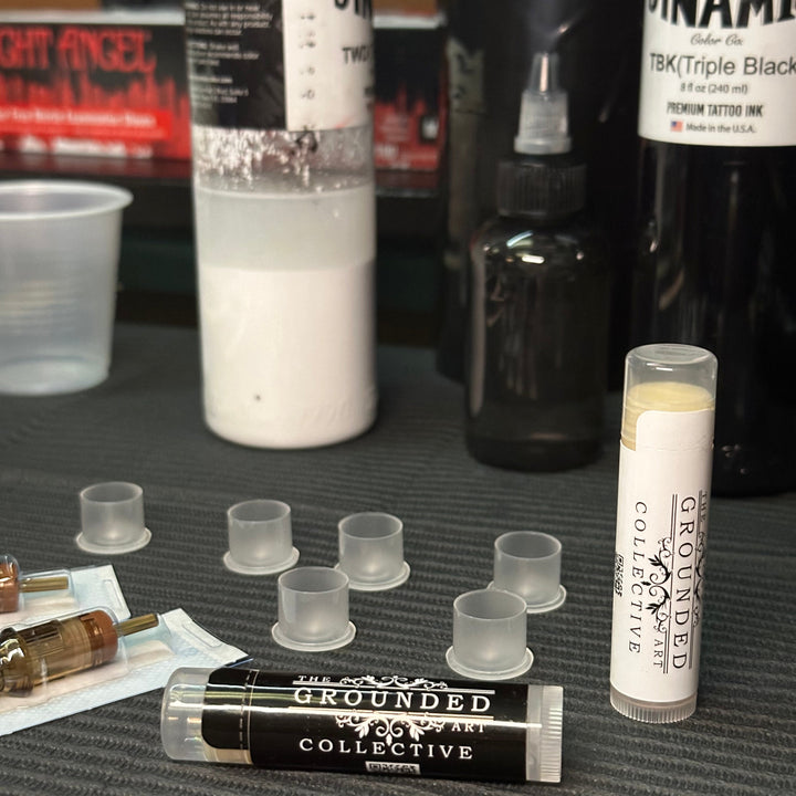 tattoo balm tubes displayed in a tattoo artists studio shop
